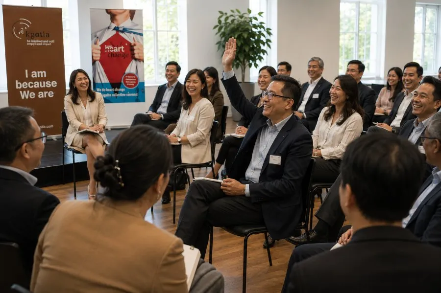 Participants seated in rows during a dialogue session, with an “I am because we are” banner