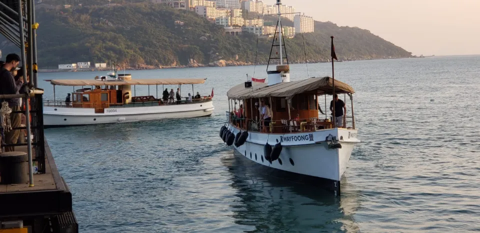 Two historic harbour launches near a pier