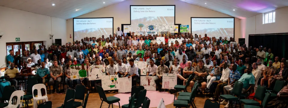 Hundreds of participants seated in a large hall during a Kgotla® Intervention
