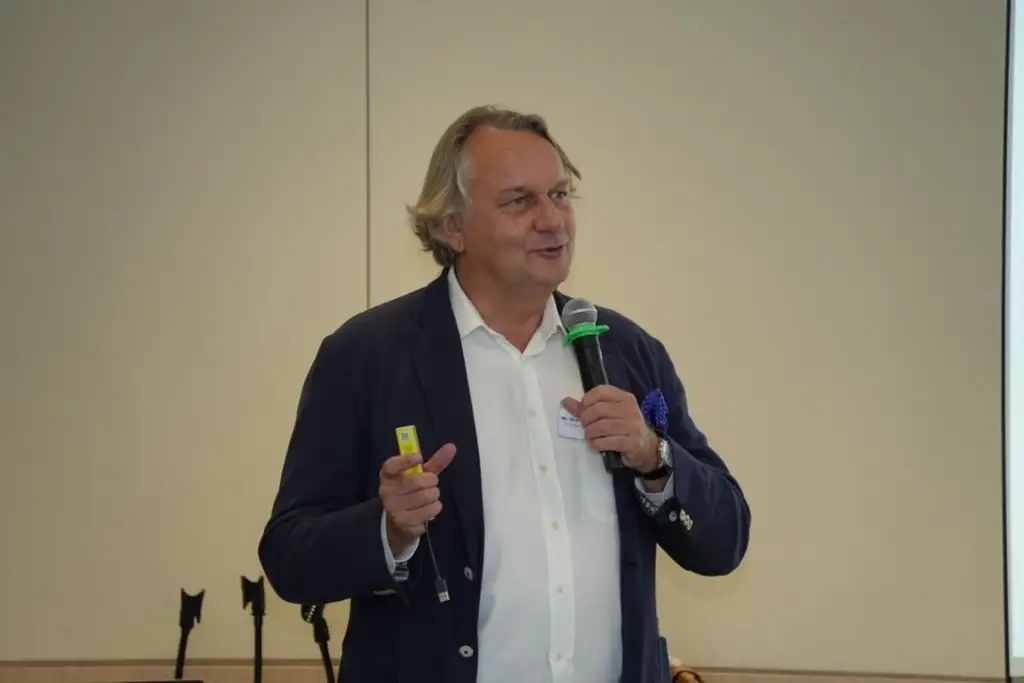 Facilitator speaking into a microphone during the dialogue