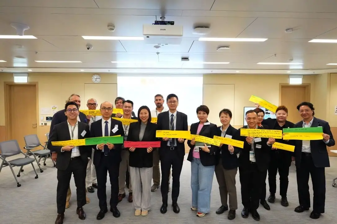 Forum participants holding up coloured strips with their priorities
