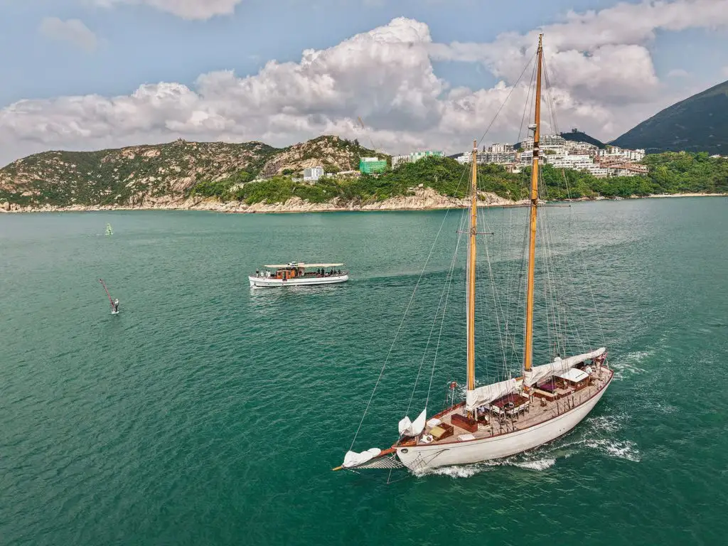 So Fong under sail along Hong Kong’s green coastline, seen from above
