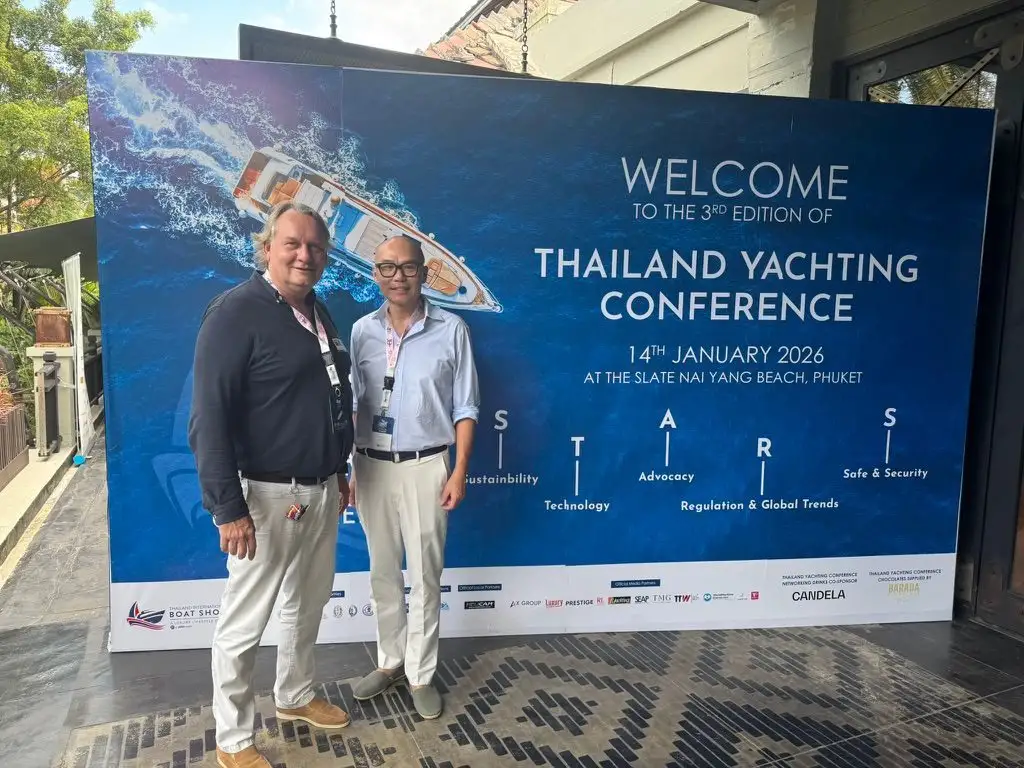 Two participants in front of the Thailand Yachting Conference welcome board, 14 January 2026