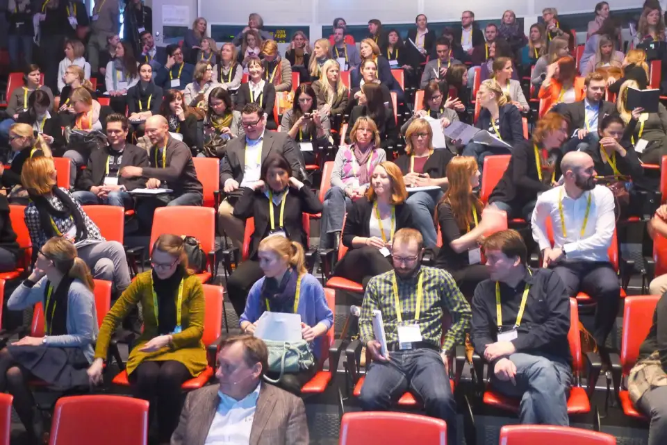 EY HR leaders seated in rows of red chairs