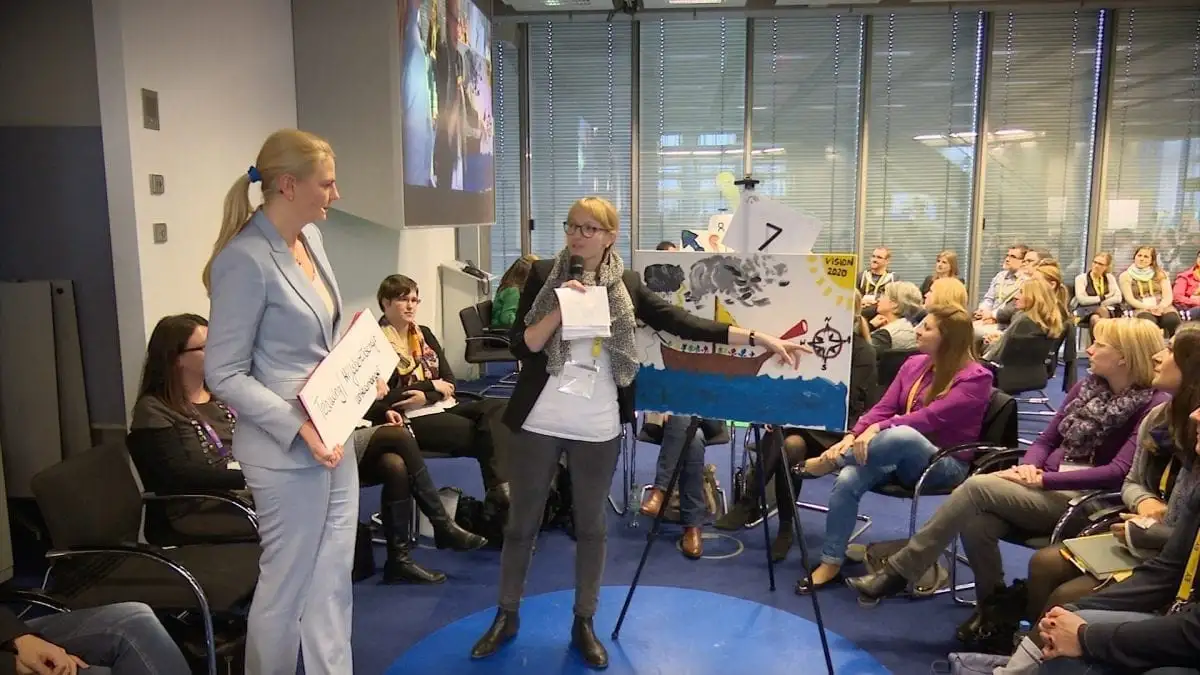 Participants presenting a hand-drawn boat during a dialogue session