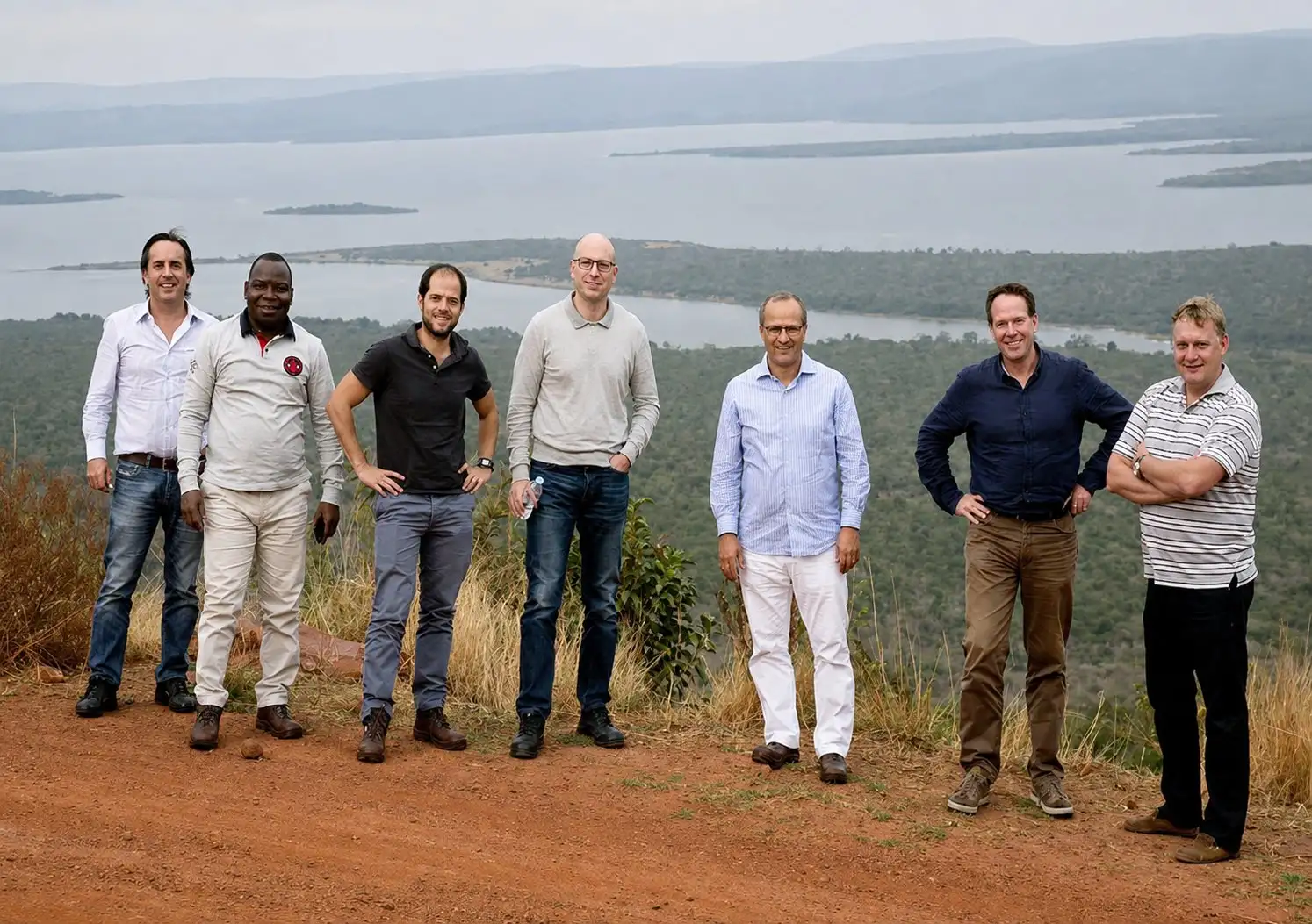 Managing Directors standing on a hillside above a lake