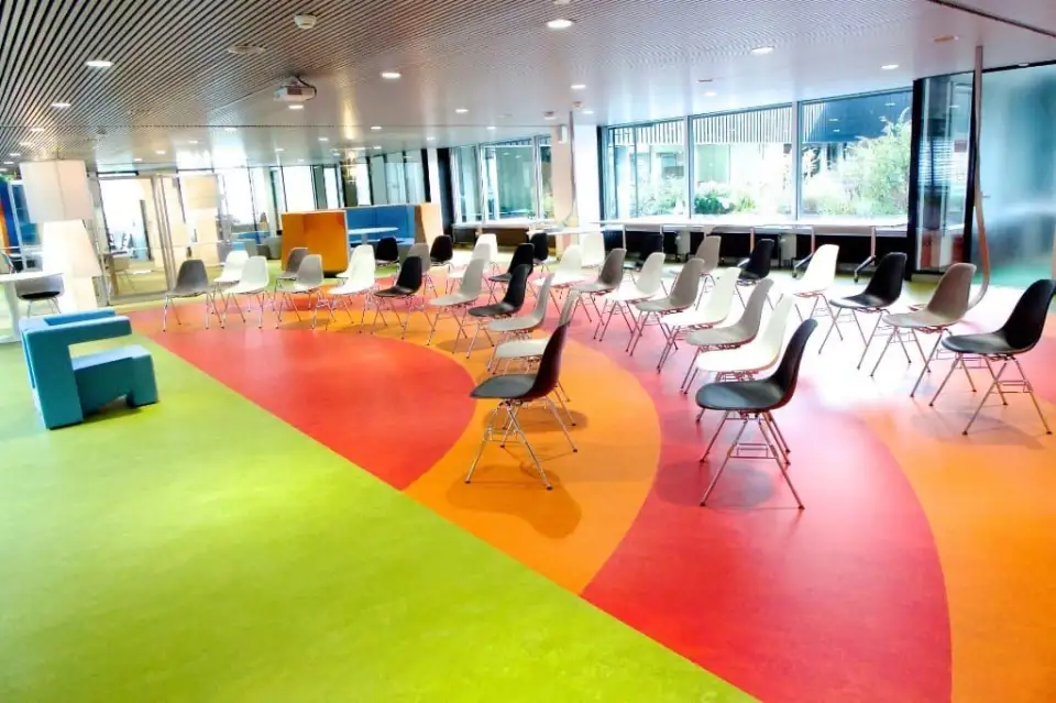 The Kgotla Workplace at KLM: chairs in circles on a colourful floor