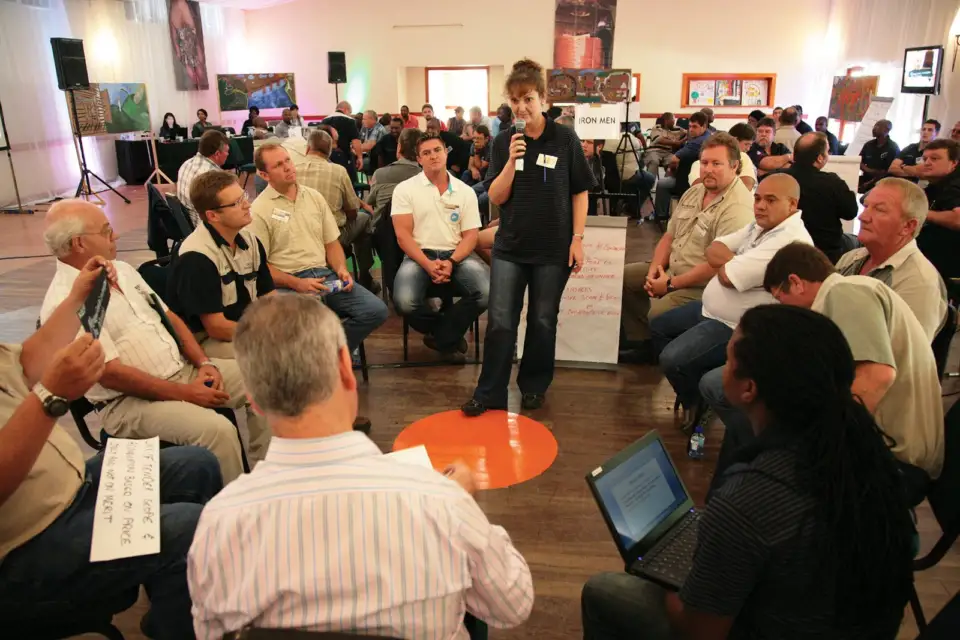 Participants in discussion in a crowded room