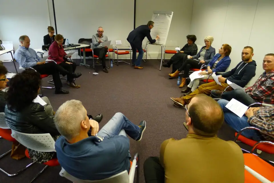 Small group dialogue in a circle of chairs