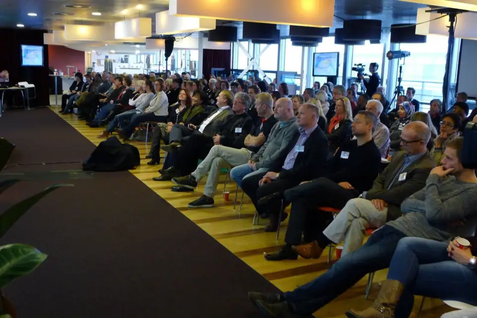 Large audience seated in rows during a Kgotla session