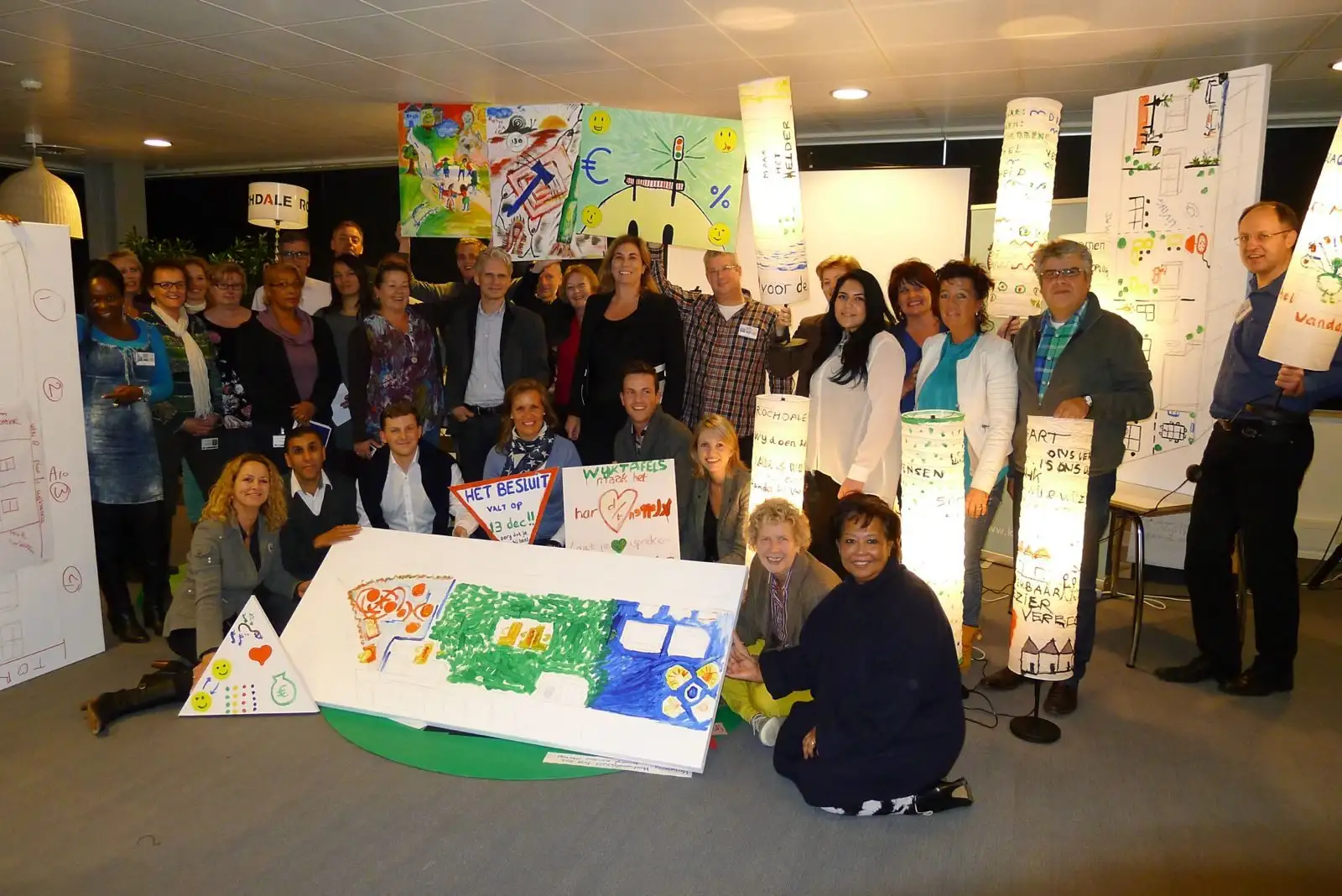 Rochdale employees holding up their colourful drawings during a Kgotla dialogue